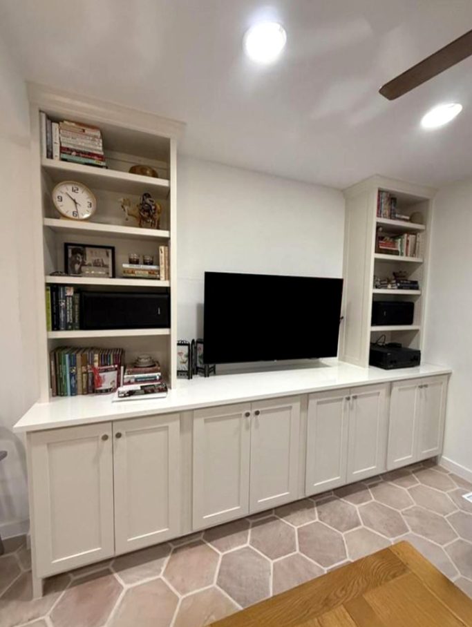Living room built-in media cabinet with shelves and closed storage