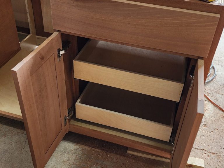 Close-up of a sapele cabinet doors with internal drawer system.