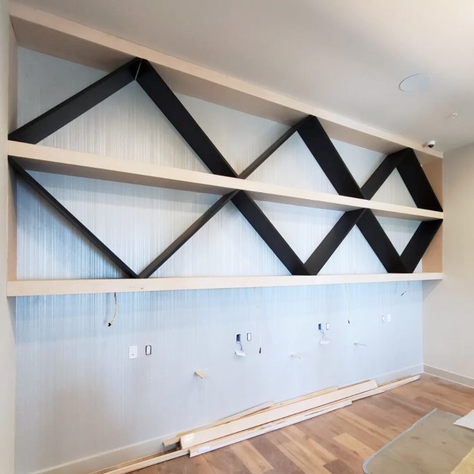 Custom geometric wall shelving installation in commerical interior space