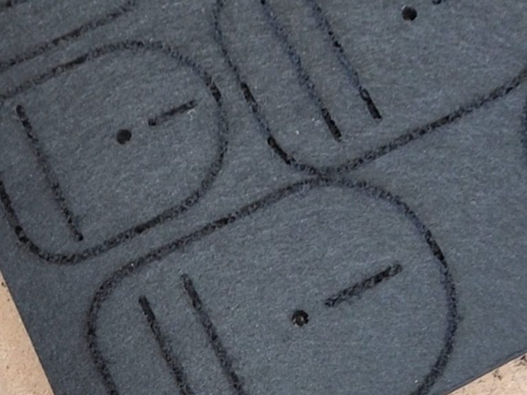 Acoustical felt with repeated cnc-cut shapes.
