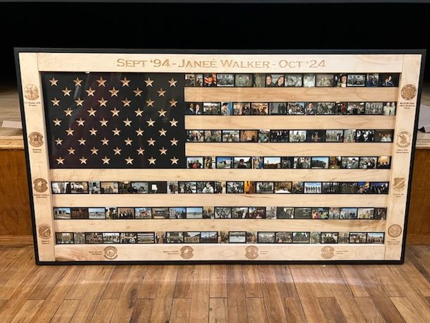 Framed wood U.S. Flag displaying rows of photographs for the stripes.