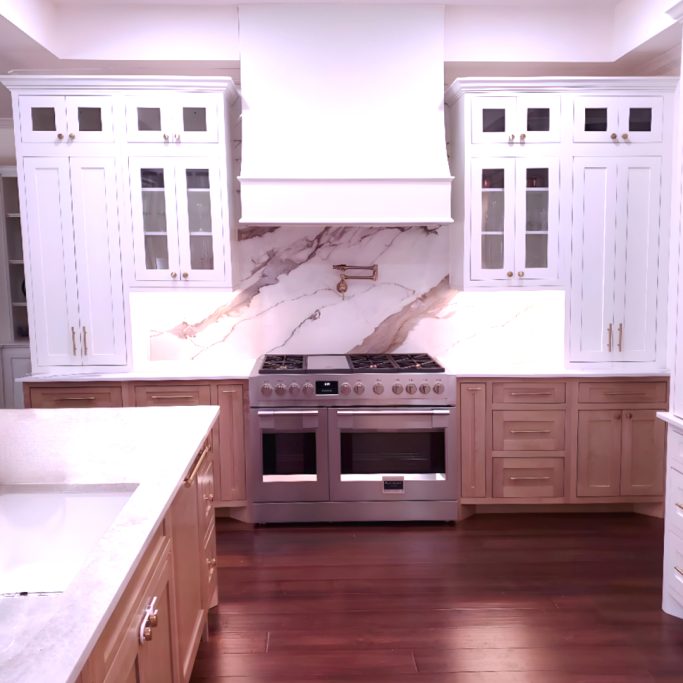 Kitchen island cabinetry with natural wood finish and painted inset cabinets
