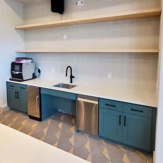 Commercial breakroom cabinetry wtih sink, open shelving, and lower cabinet storage