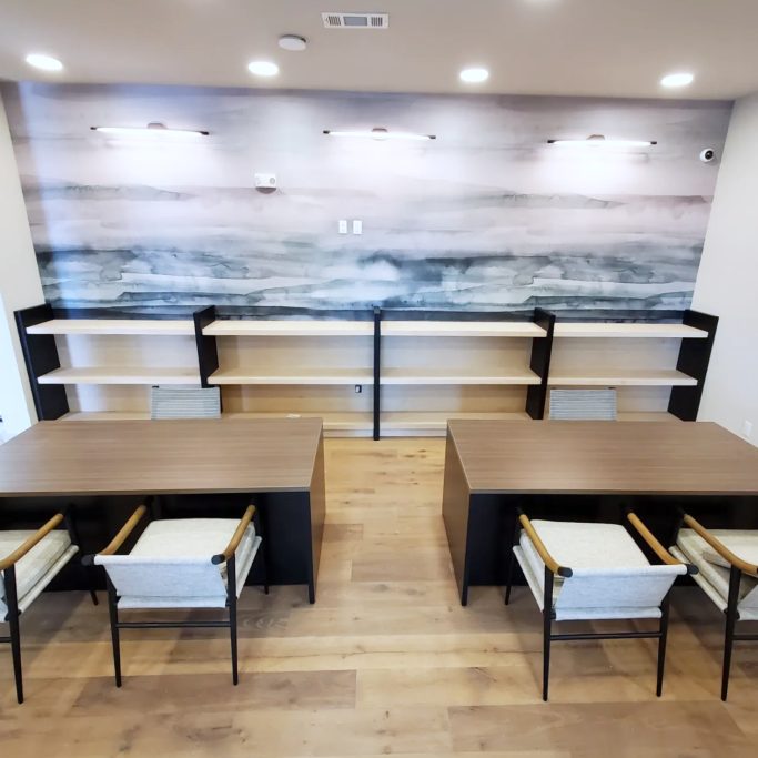 Commercial seating aera with custom wall mounted shelving installation