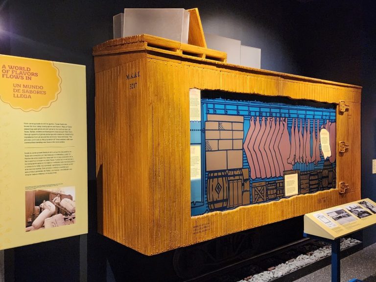 Ice Reefer Car Display Half-scale wooden railcar exhibit with an open side showing the illustrated interior and a short section of track.