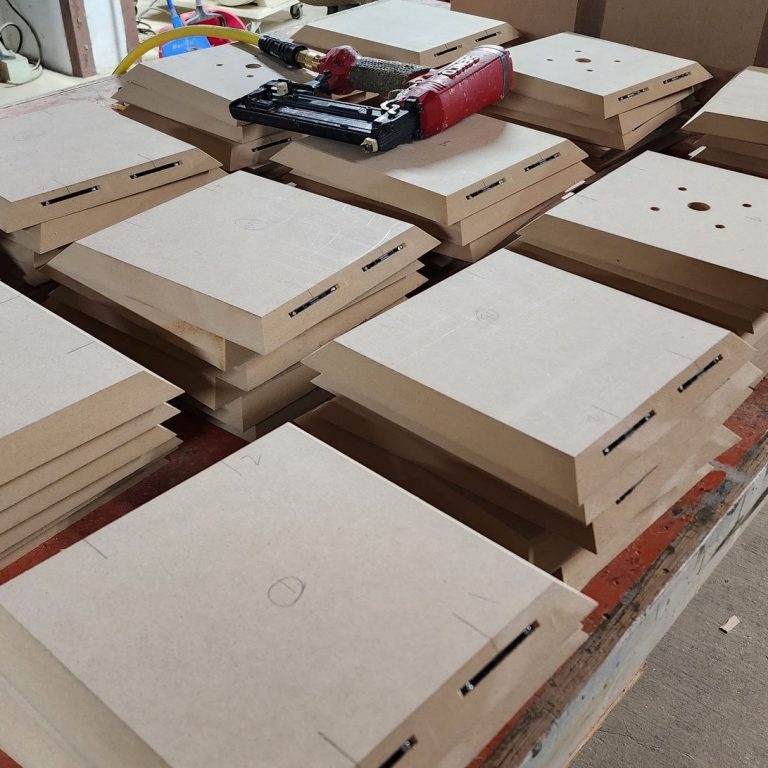 Precision cut components arranged across a work surface